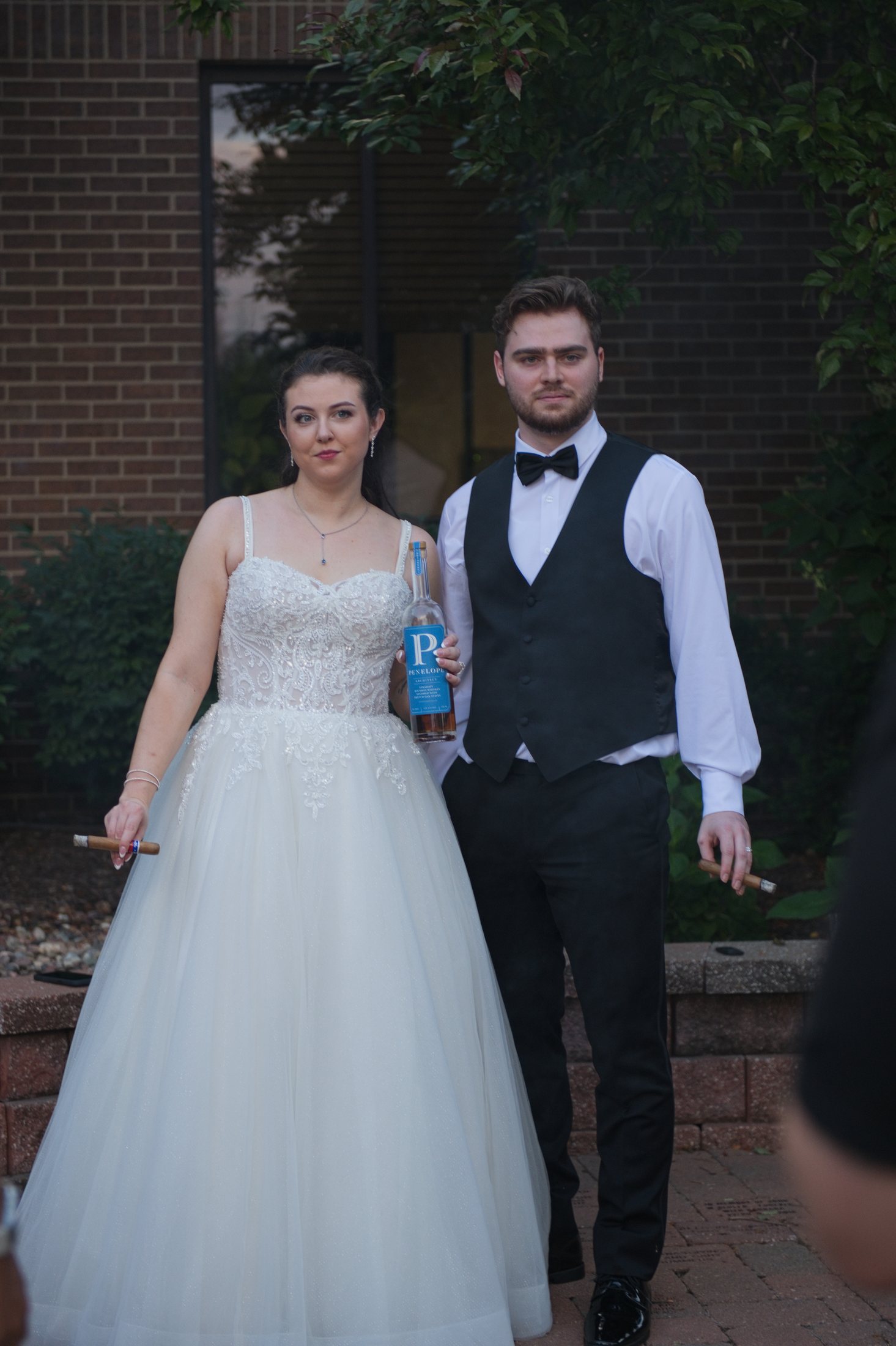 Brennan and Jocilyn standing together in their wedding attire